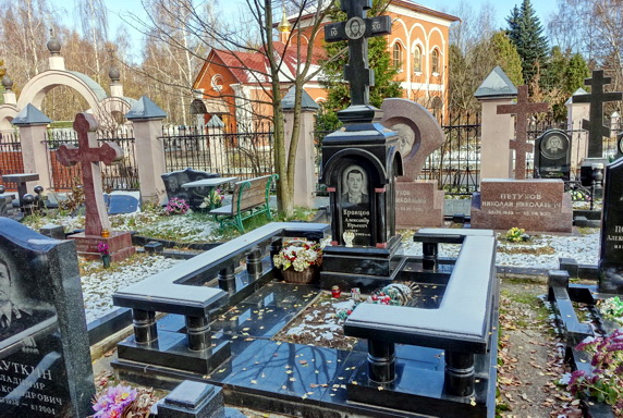 Вертикальная стела из чёрного гранита с цветником без бортов
